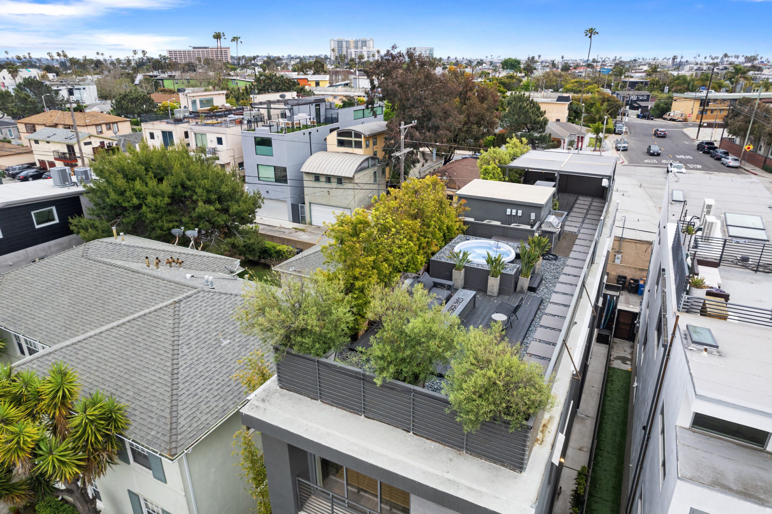 The rooftop area offers secluded outdoor space surrounded by lush botanicals.